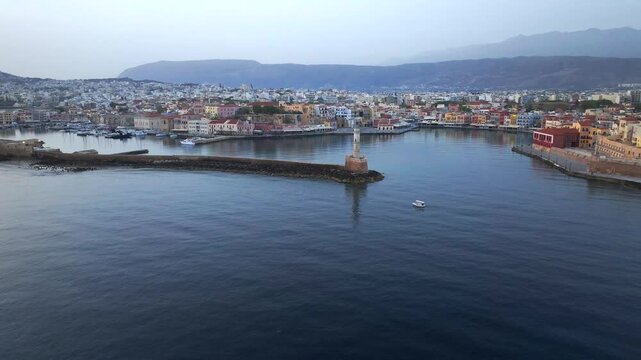  View of Chania with the amazing lighthouse, mosque, venetian shipyards, Crete, Greece.Waves crashing on lighthouse, Beautiful Greece and best scenic places - panorama