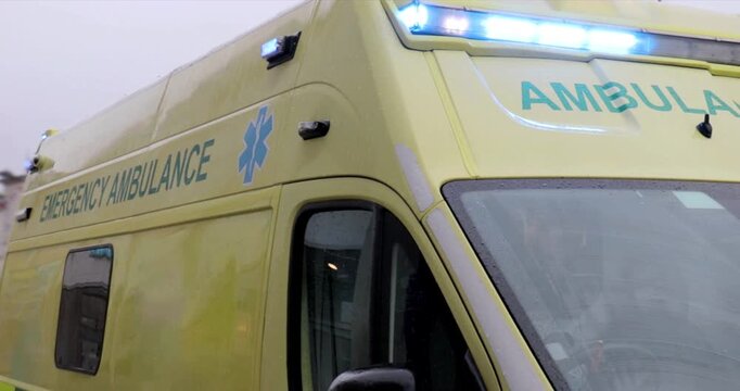 Ambulance - Emergency services ambulance with flashing blue lights in response to a medical incident.