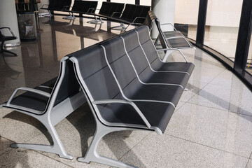 Empty airport seats wait quietly. Bright terminal feels spacious inside. Modern travel background suits transportation themes. Calm atmosphere before boarding. © Paweł Michałowski