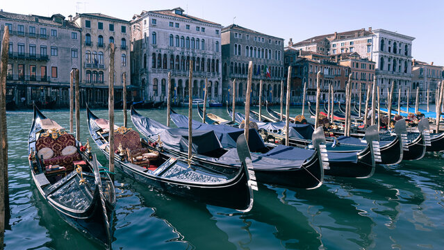 Narrow canal of Venice, gondolas on the water, architecture of buildings