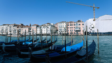 Narrow canal of Venice, gondolas on the water, architecture of buildings © liusan 