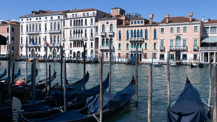 Narrow canal of Venice, gondolas on the water, architecture of buildings © liusan 