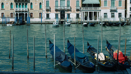Narrow canal of Venice, gondolas on the water, architecture of buildings © liusan 