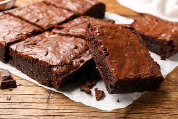 Naklejka na ściany i meble Yummy chocolate brownies on wooden table, closeup