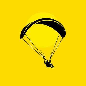Paragliding Silhouette Against Vibrant Yellow Sky