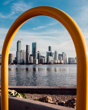 Miami Brickell Skyline Framed by Yellow Railing Across Biscayne Bay
