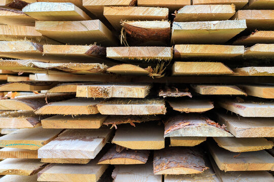 Texture of stacked lumber boards. The raw material from the sawmill is ready for construction, carpentry