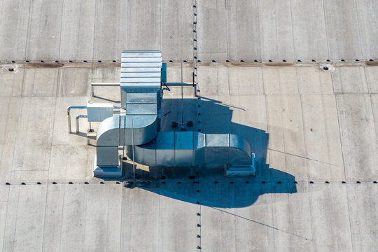 Aerial view of industrial HVAC ventilation ductwork and equipment installed on a flat roof of an advanced motorboat production facility in Poland.