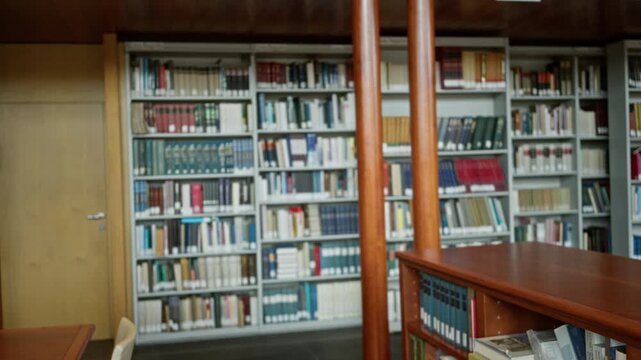 Library reading room shelves softly blurred with shallow bokeh interior, wooden desk and book stacks defocused for quiet study; background backplate copyspace calm.