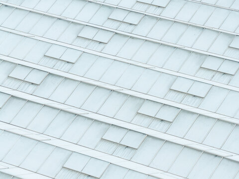 Aerial view of a production scale greenhouse with glass panels and ventilation hatches in Poland.
