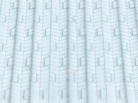 Aerial view of a production scale greenhouse with repeating glass panels and ventilation hatches in Poland.