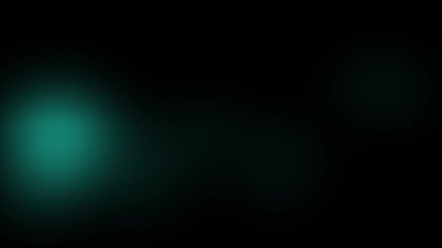 A soft and subtle teal light glow emerges from the darkness in this smooth abstract motion clip.