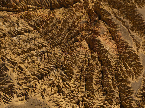 Aerial view of arid landscape with deep erosion gullies and rugged ridges in the high altitude terrain of Nepal.