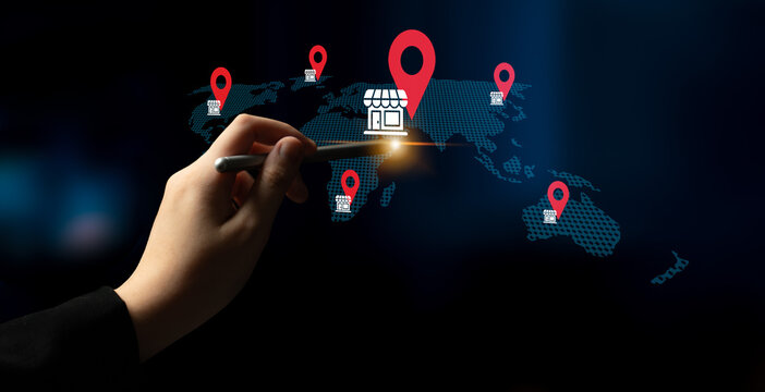 A hand interacts with a digital map showcasing store locations across the globe, symbolizing business strategy and the impact of technology on commerce. Gantry
