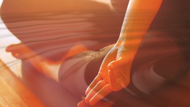 Warm left light initiating ripple, female-presenting yogi holding mudra, breathing, calming rhythm