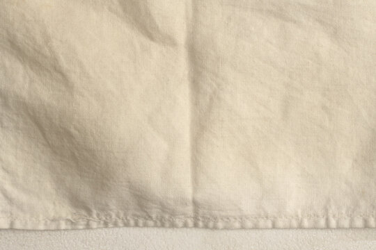 Crumble fold paper, fabric rustic canvas pieces collage. Gray, beige white copy space grunge dirty relief texture poster background.