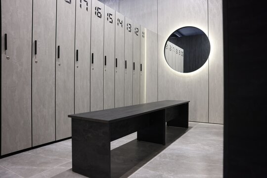 Bench, lockers and mirror in gym changing room