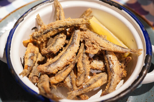 Spanish Boquerones Fritos, crispy deep-fried anchovies served with lemon