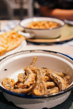 Spanish tapas dish of fried anchovies boquerones fritos served in an enamel bowl