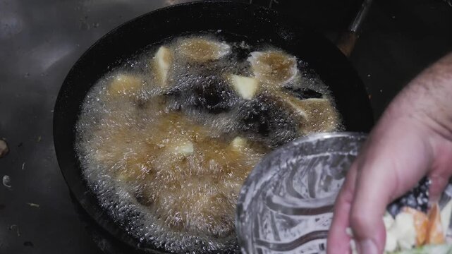 Deep Frying Battered Vegetables in Hot Wok Oil.