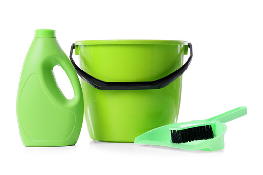 Green cleaning supplies including a plastic bucket, detergent bottle, dustpan, and brush for household chores