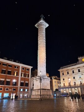 a column in a square at night in rome italy