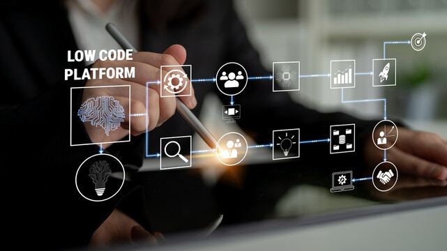 Business professional working with low code platform technology on a tablet, illustrating digital tools and workflow automation for innovation and efficiency Quark.