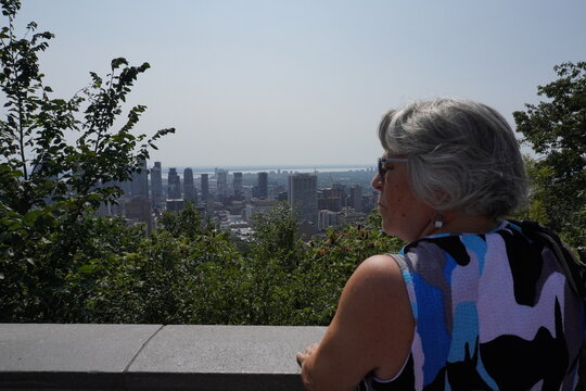 senior retired woman looking at Montreal from the belvedere