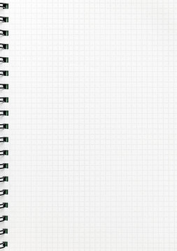 Blank checkered spiral notebook page with grid pattern and copy space, clean stationery background for online learning, study at home, homework, writing practice, planning, worksheets and education