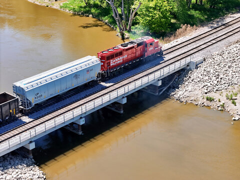 Savanna, Illinois May 14, 2026 Canadian Pacific 2326 Switching locomotive in bright red livery on mainline track crossing a concrete bridge.