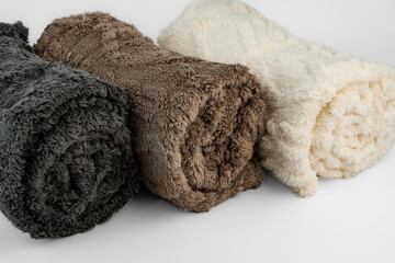Three Rolled Plush Blankets in Grey Brown and Cream © Алексей Божко
