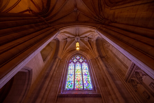Washington, District of Columbia, United States - 06 May 2025: View of the stained glass window and vaulted stone ceiling inside the Washington National Cathedral.