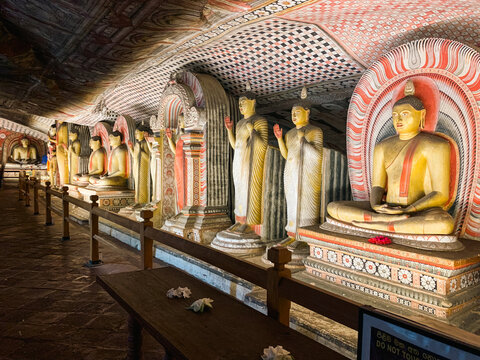 Dambulla, Sri Lanka - 20 April 2024: View of the ancient Buddha statues inside the Dambulla Cave Temple, featuring intricate wall paintings and ornate stone carvings.
