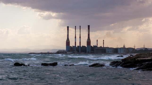 Industrial Electricity power plant with smokestacks releasing smoke, representing energy production, climate change, and environmental pollution. Dhekelia power station Cyprus