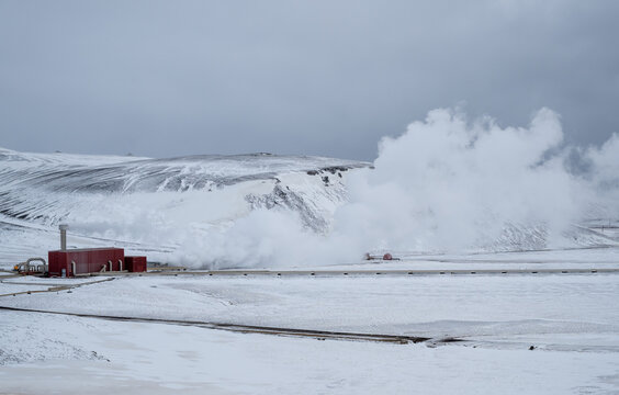 Krafla power plant creating renewable energy from geothermal steam in a snowy, volcanic iceland landscape