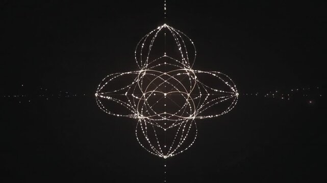 Starting with central orb, glowing filaments forming four lobes to settle pattern in black backdrop