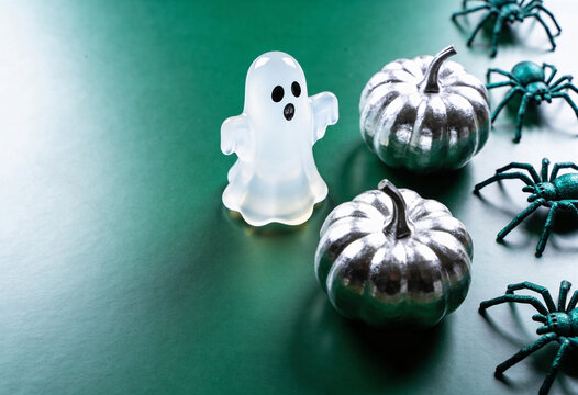 Halloween decor, cute ghost, silver pumpkin, spooky spider, autumn holiday, dark green theme, metallic spirit, ghost figurine, creepy crawler, festive party, seasonal arrangement, october celebration.
