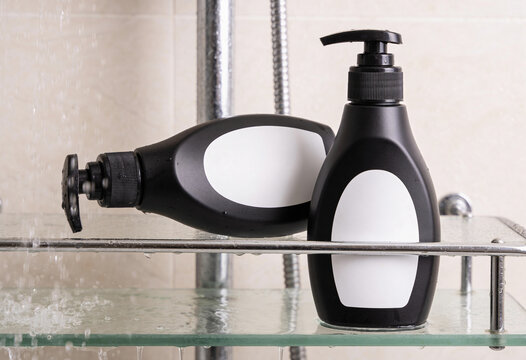 Black shampoo bottle, lotion dispenser, body wash container, cosmetic mockup, plastic bottle, shower gel, bathroom shelf, liquid soap, blank packaging, care product, bath element, hygiene container.