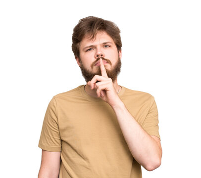 Bearded young man making a hush gesture with finger near lips, isolated on transparent background, concept of silence, secrecy, confidentiality and keeping a secret.