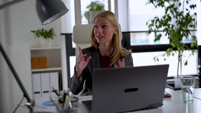 Professional businesswoman delivering an online presentation during a virtual meeting, explaining business results, strategy, and project updates in a contemporary office.