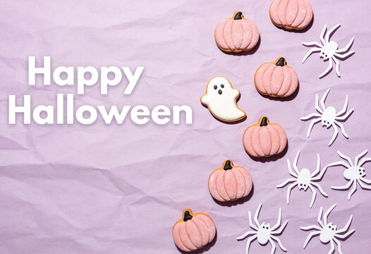 Happy halloween, autumn season, spider decor, pumpkin theme, halloween treats, ghost decoration, pink pumpkin, festive arrangement, halloween concept, purple surface, flat lay composition.