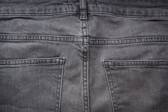 Gray view of gray denim jeans with pockets and stitching detail.