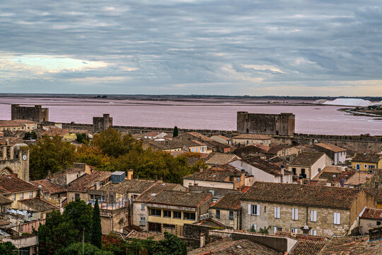 The pink salt lake and the medieval walled Old town of Aigues-Mortes, Camargue, France