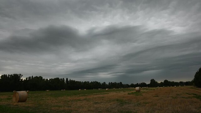 Time lapse of dramatic stormy skies over a harvested field near Modena, Italy