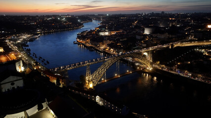 Fototapeta premium Sunset Luis I Bridge In Porto Portugal. Elevated Road Bridge Symbol Of The City Viewed From Above. Building Metropole Skyline Bird View Awesome. Cityscape Bird View. Porto Portugal.