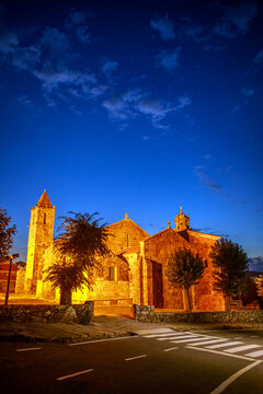 Night-time landscape against the backdrop of evening sky, with Catholic church illuminated by streetlights