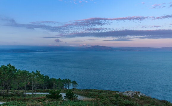 Evening landscape of the peninsula, overlooking the ocean and the coastline with mountains against a sunset sky