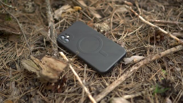 Camera Pushes Toward Lost Smartphone Lying in Forest