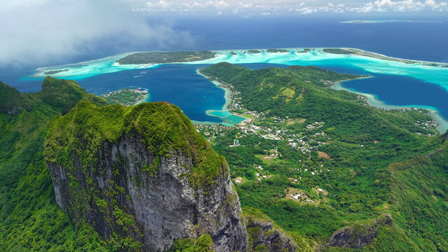 Photo of French Polynesia tropical paradise 
island Bora Bora in Pacific Ocean. Drone aerial view.
Sandy beach, palm trees, coral reef, azure ocean, sky 
with clouds on horizon. 
