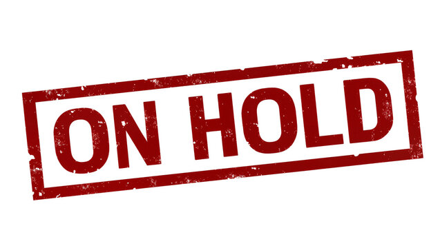Isolated red grunge rubber stamp with 'ON HOLD' text, indicating a paused status or delay.